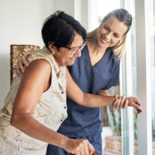 caregiver assisting the elderly woman