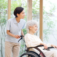 caregiver and elderly woman smiling