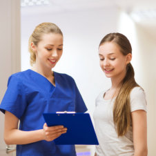caregiver and young girl smiling
