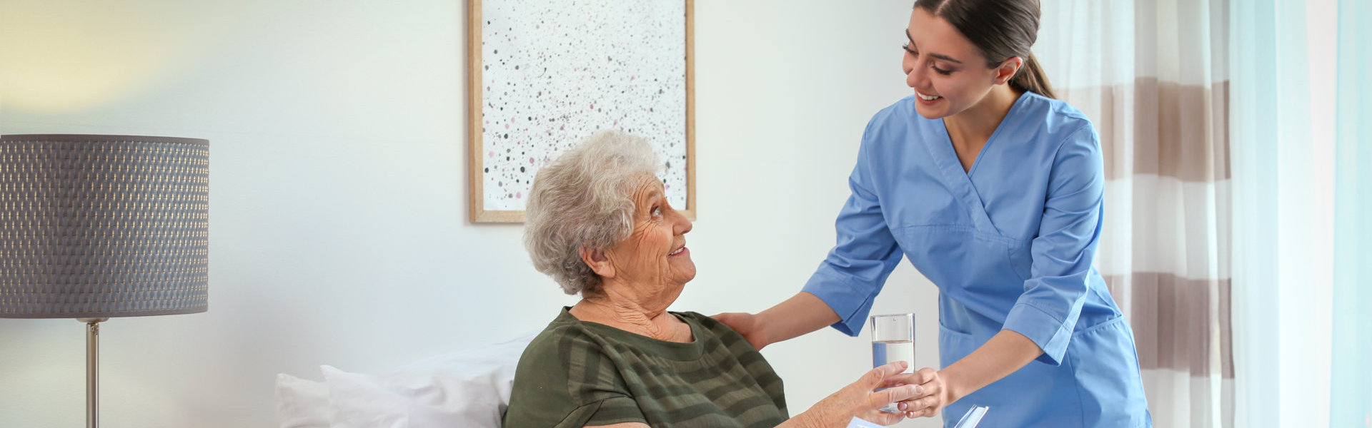 caregiver assisting the elderly woman
