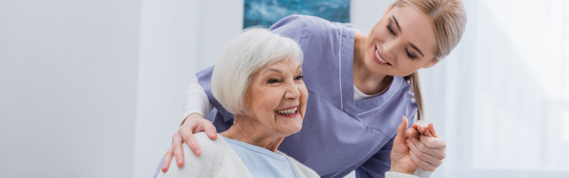 caregiver and elderly woman smiling