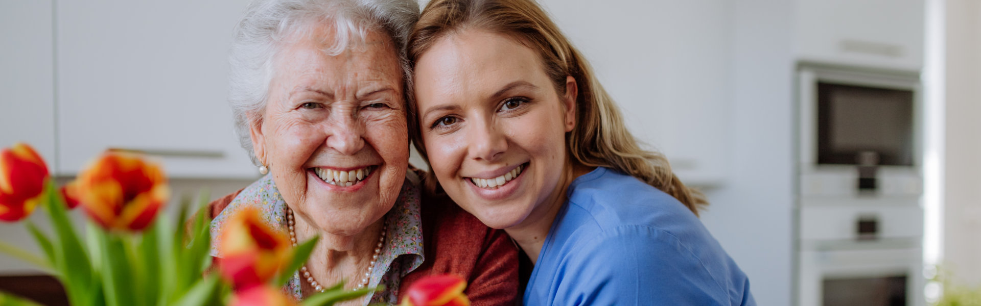 caregiver and elderly woman smiling