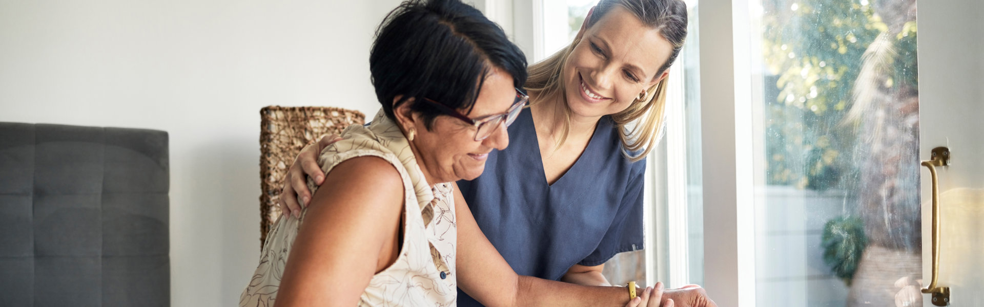 caregiver assisting the elderly woman