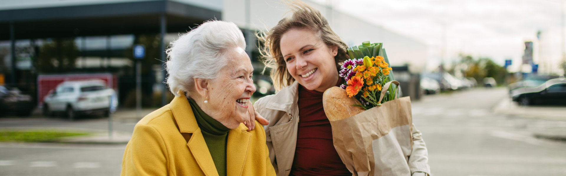 caregiver and elderly woman smiling