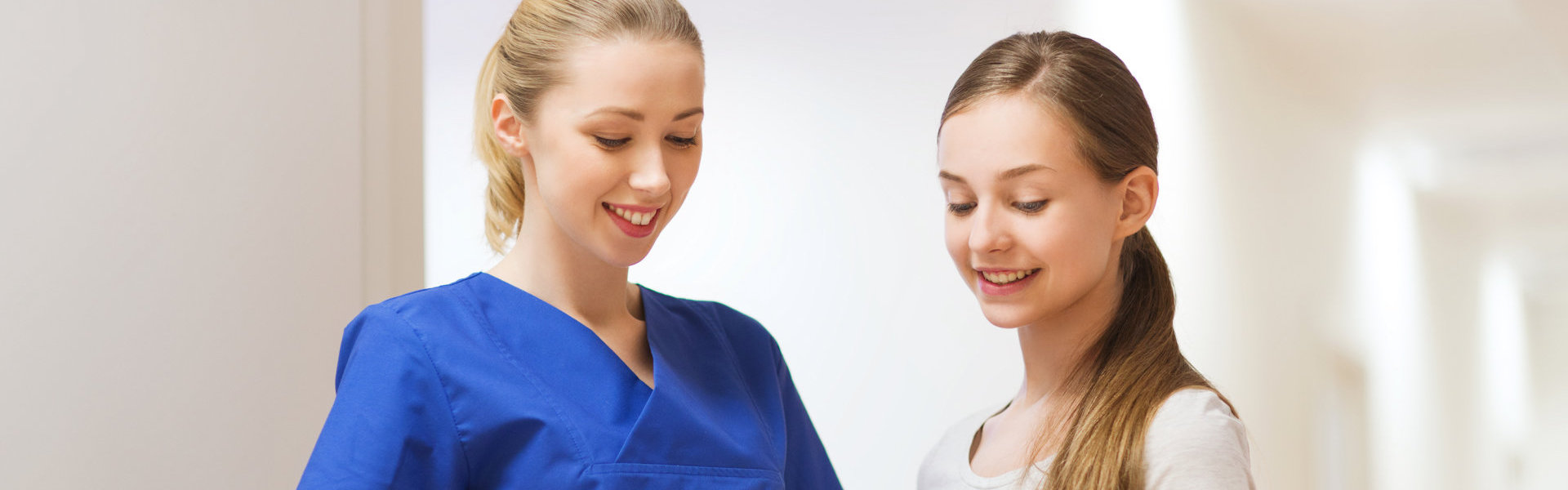 caregiver and young girl smiling