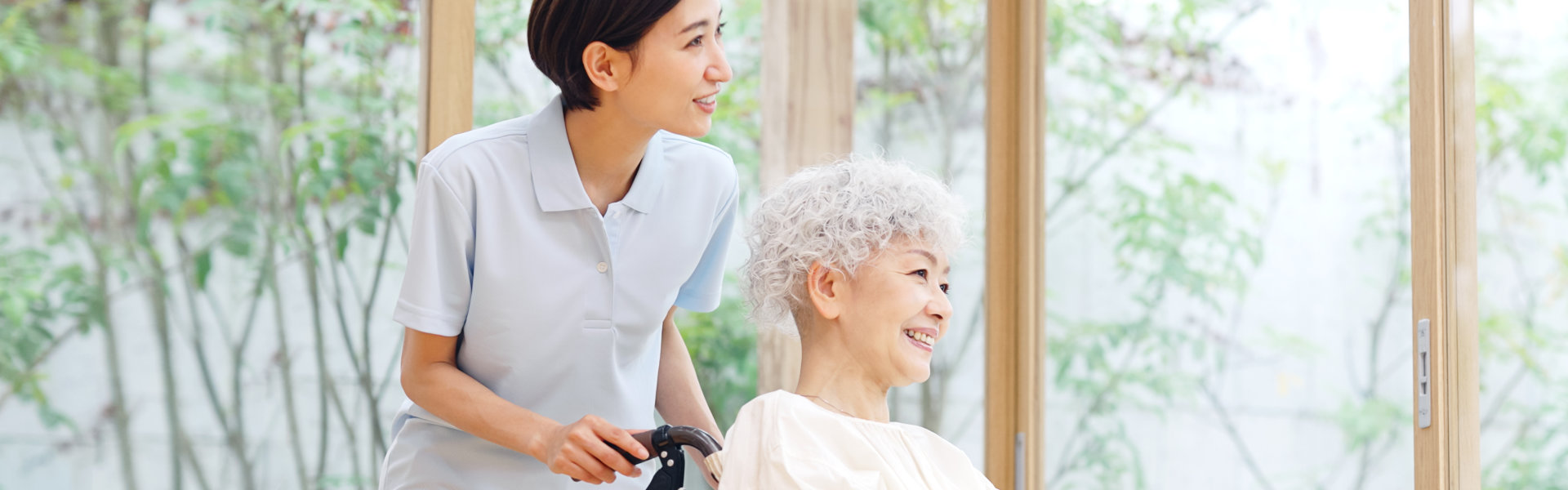 caregiver and elderly woman smiling